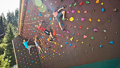 Children on the climbing wall and at the Jump and Slide Park in Saalbach Hinterglemm